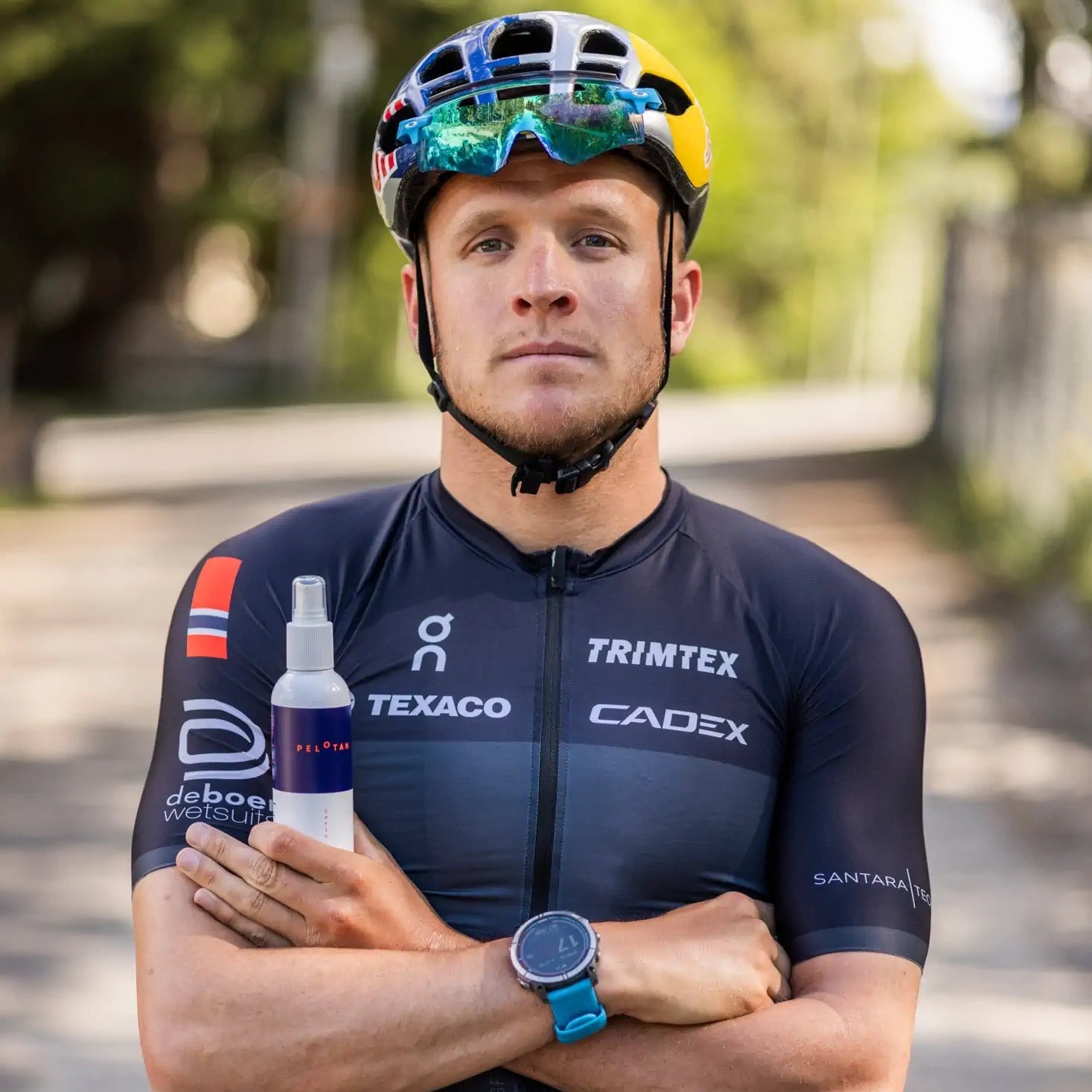 Kristian Blumenfelt holding a bottle of Pelotan - the Sports Sunscreen