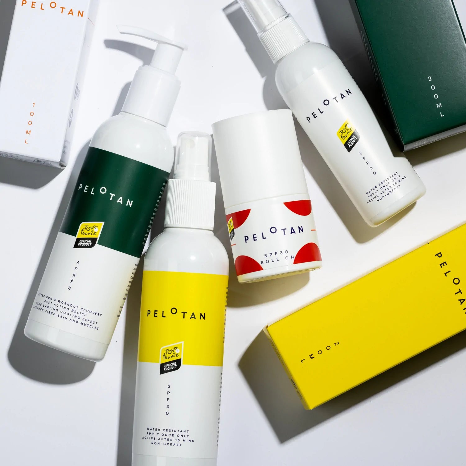 Bottles of Pelotan’s recovery and performance sunscreen products are laid on a white background, showing products that are official products of the Tour de France.