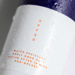 Close-up of the Pelotan 100ml sunscreen spray bottle label showing its SPF30 marking.