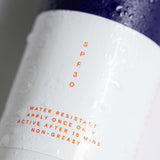 Close-up of the Pelotan 100ml sunscreen spray bottle label showing its SPF30 marking.