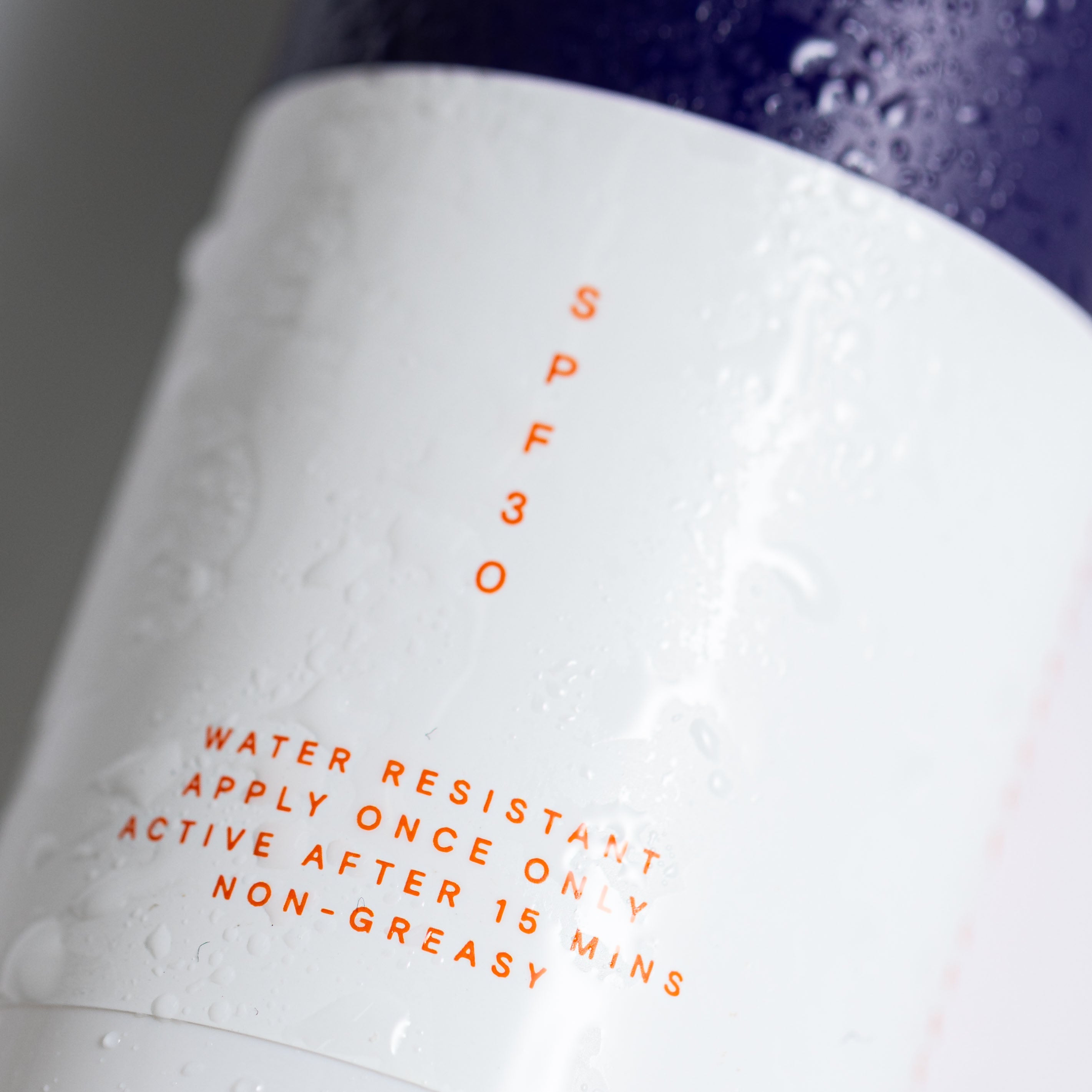 Close-up of the Pelotan 100ml sunscreen spray bottle label showing its SPF30 marking.