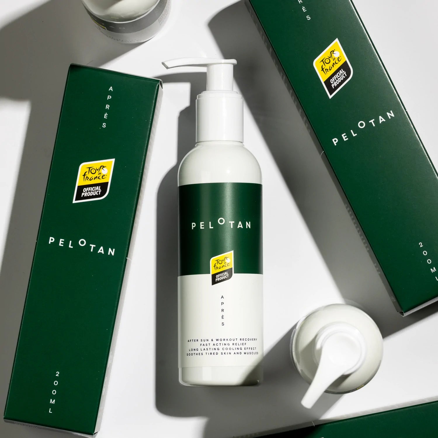 Bottles of Pelotan’s recovery product is laid on a white background, showing products that are official products of the Tour de France.
